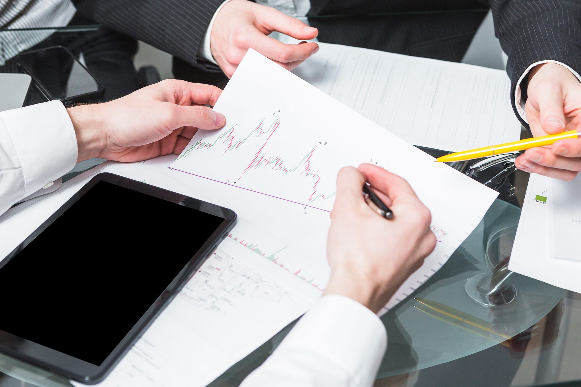 compliance-and-risk-management A Person Writing on a Paper with Graph<br />